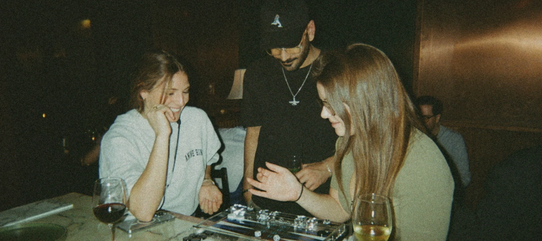 People with drinks and backgammon boards